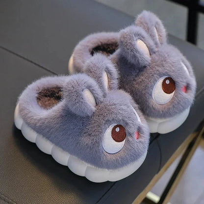 Kids rabbit plush winter slippers, fluffy gray with big brown eyes and tan ear tips