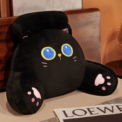 Black plush reading pillow with blue-eyed character graphic and paw accents