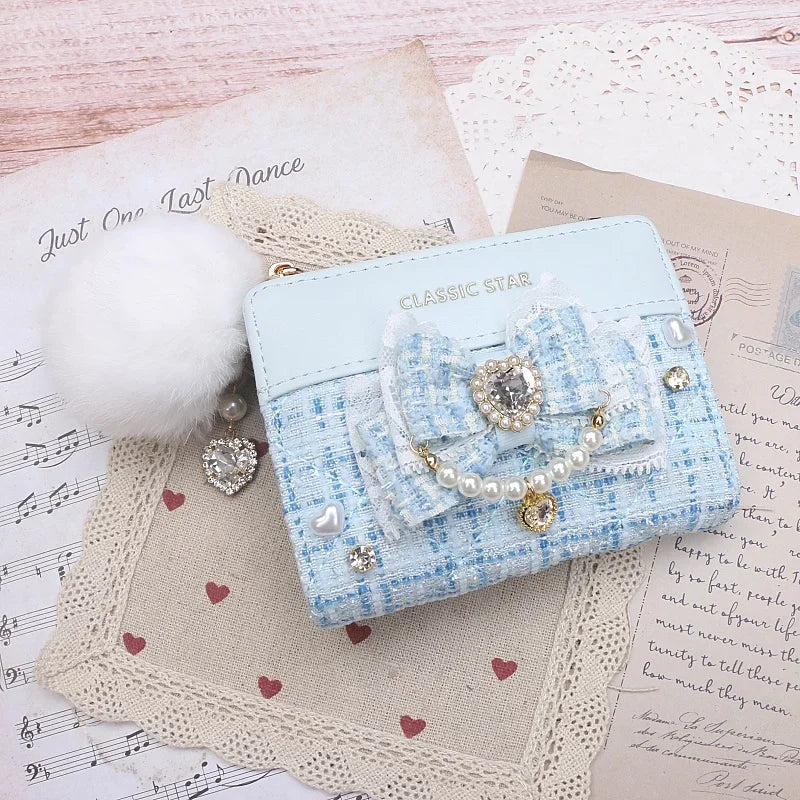 Light blue quilted wallet with heart charm bow, pearl trim, and gold-tone zipper