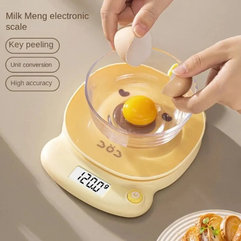 Yellow pig-face digital kitchen scale holding a cracked egg over the platform