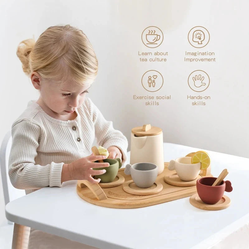 Wooden tea set on tray as a child pours into a cup
