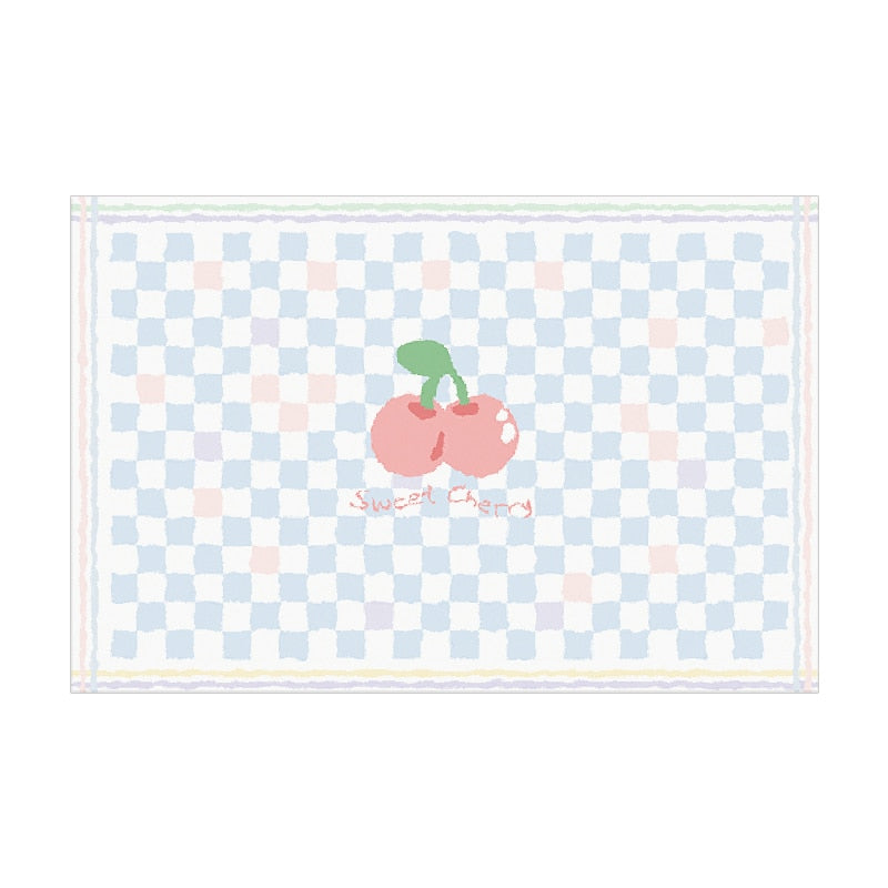 Light blue plush area rug with checker pattern and centered red cherry graphic