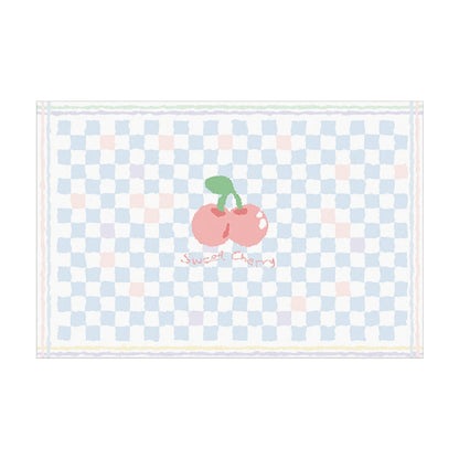 Light blue plush area rug with checker pattern and centered red cherry graphic