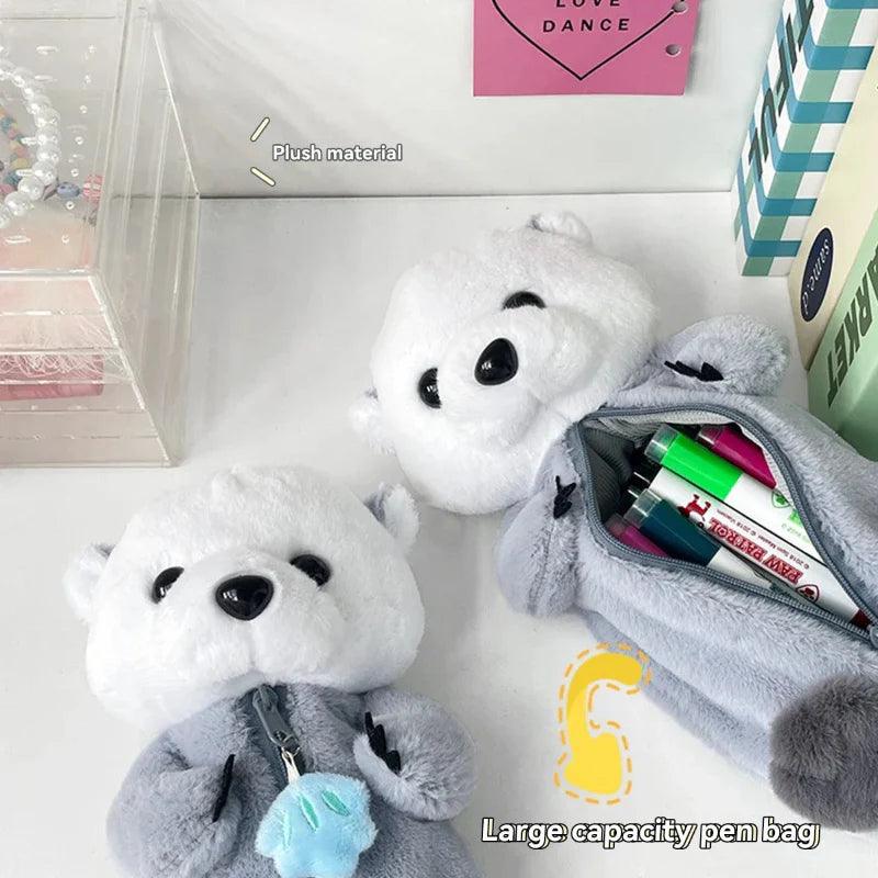 Otter plush pencil case with open zipper revealing colorful pens inside