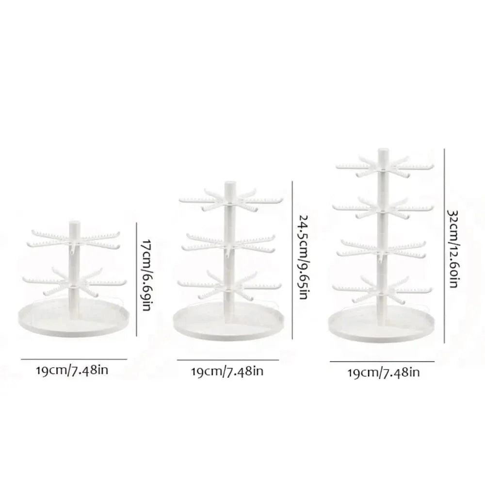 White rotating earring display stand with tiered hook arms and round base