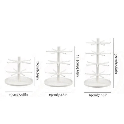White rotating earring display stand with tiered hook arms and round base