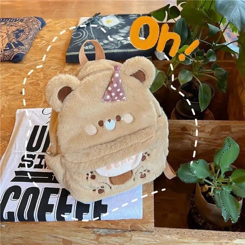 Plush bear backpack light tan with polka-dot bow, paw prints, and front pouch