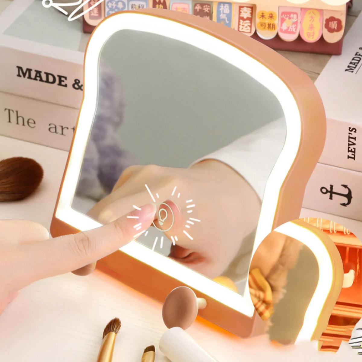 Toast-shaped LED makeup mirror, reflecting hand, warm light border and tan phone stand