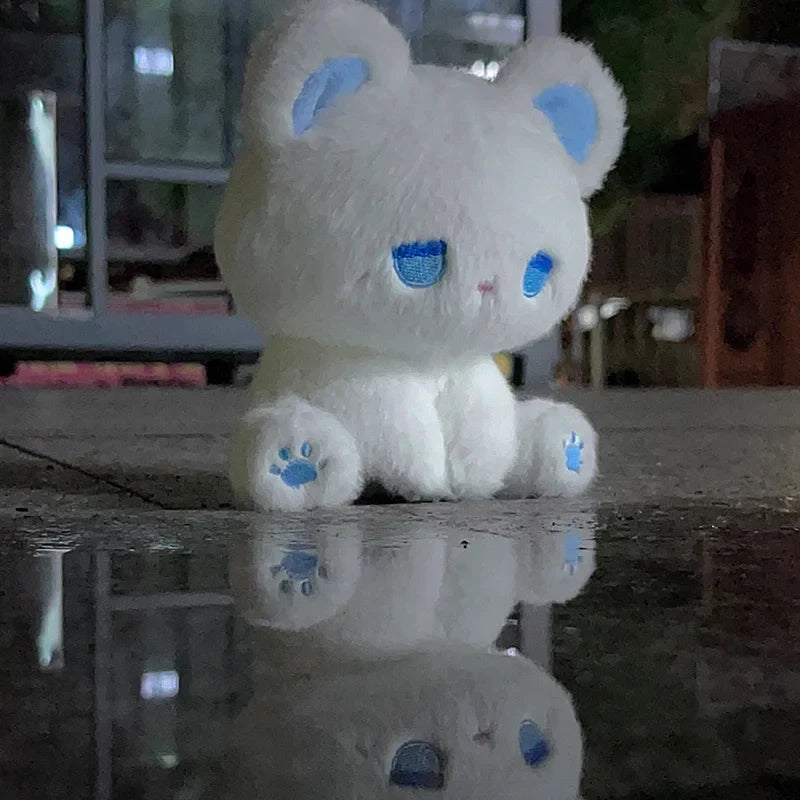 White plush cat with blue sleepy face and paw pads, soft stuffed toy