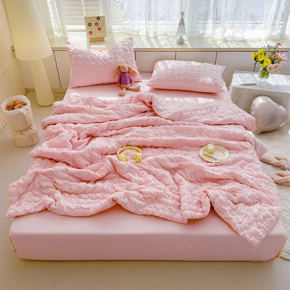 Pink seersucker duvet cover set with matching pillow shams and crinkle texture