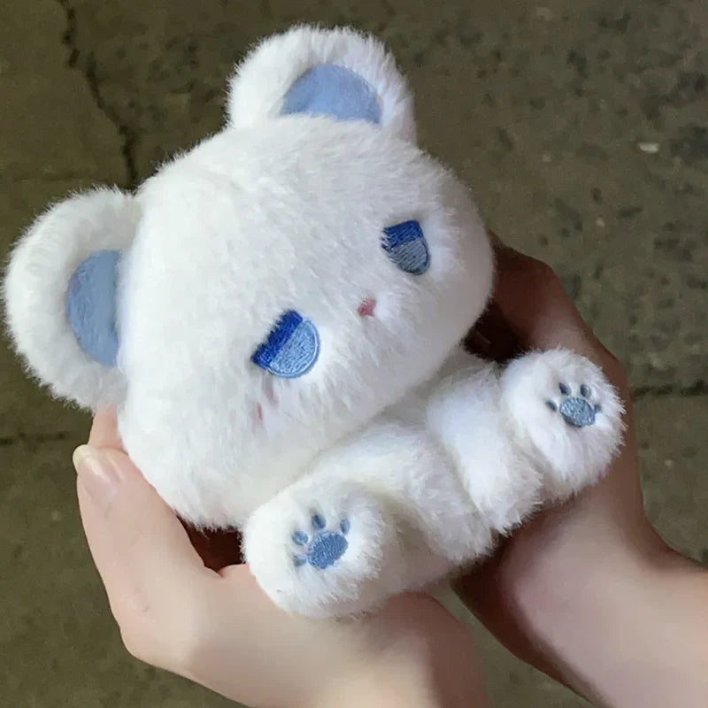 White plush cat with blue sleepy patches and paw detail, soft stuffed toy