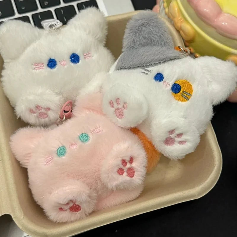 White and gray cat plush keychains with pink paw details and metal key ring