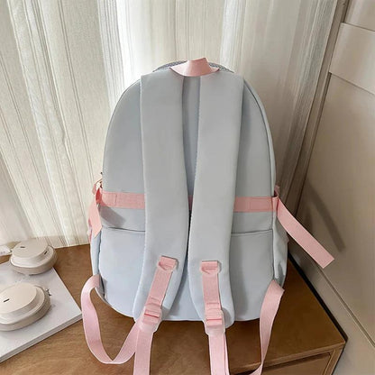 Pastel backpack with padded back, top handle loop, and adjustable shoulder straps
