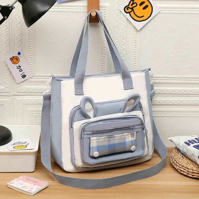 Light blue bunny ears tote shoulder bag with zip front pocket and adjustable shoulder strap