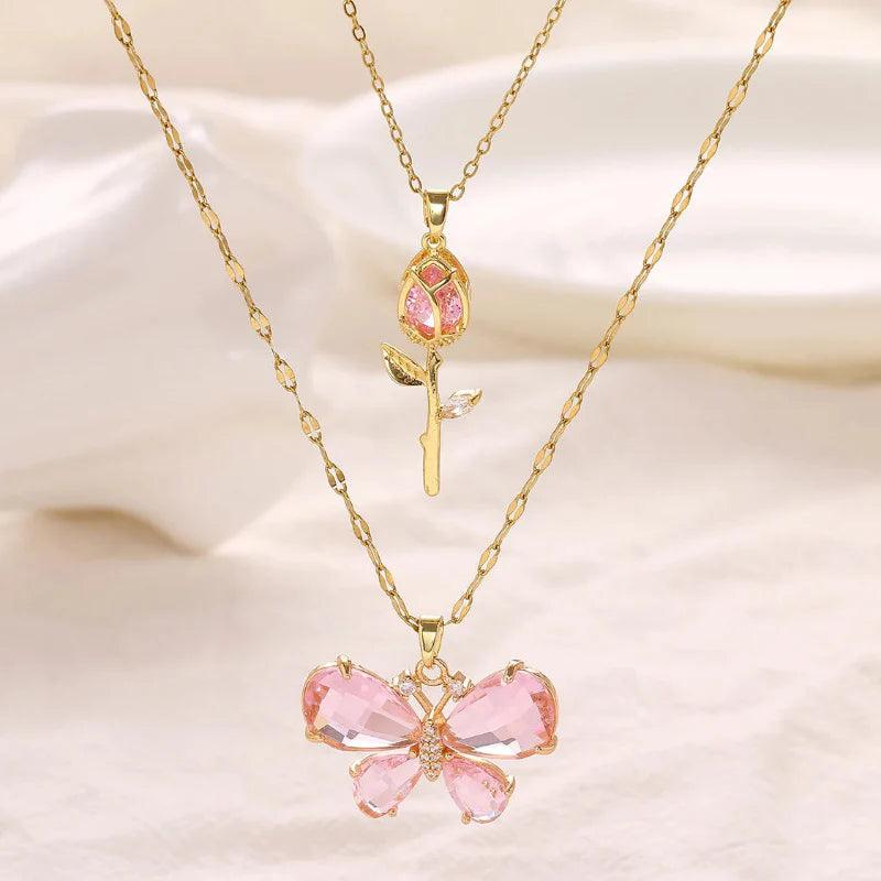 Gold-tone butterfly rose necklace with small pink rose charm and pink butterfly centerpiece