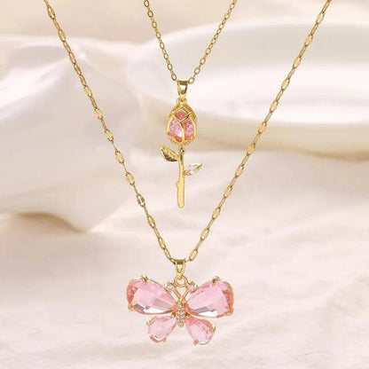 Gold-tone butterfly rose necklace with small pink rose charm and pink butterfly centerpiece