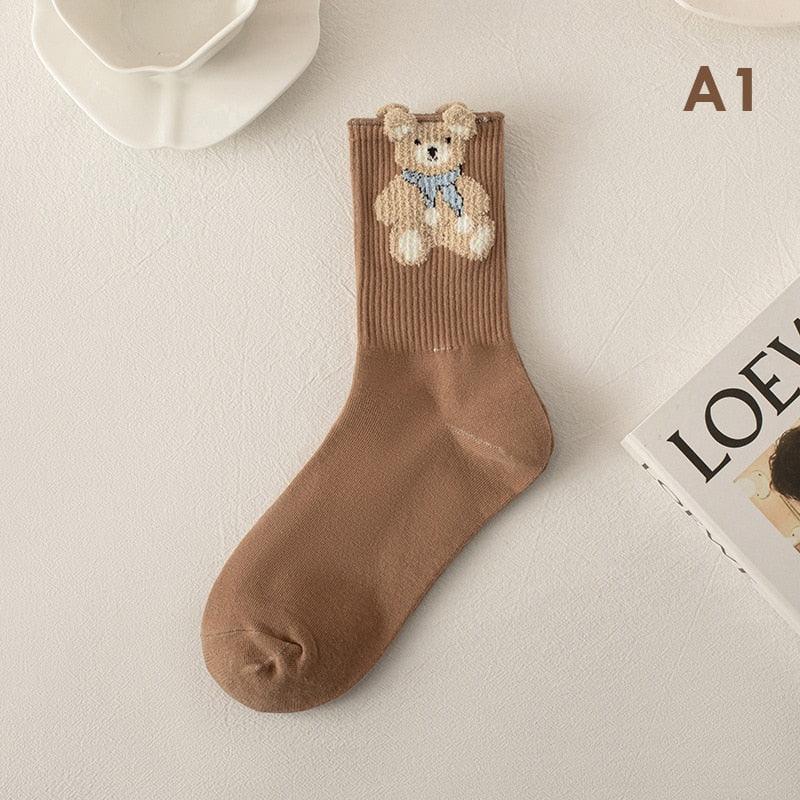 Teddy bear socks in brown with a blue scarf bear illustration on the ankle