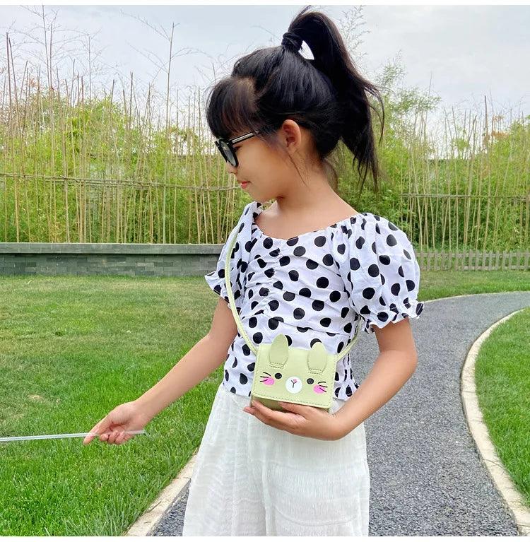 Children's bunny crossbody bag, light green with cute face graphic and shoulder strap