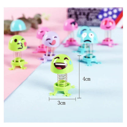 Spring elf toy figure with face sticker, green base and coil, shown with size guide