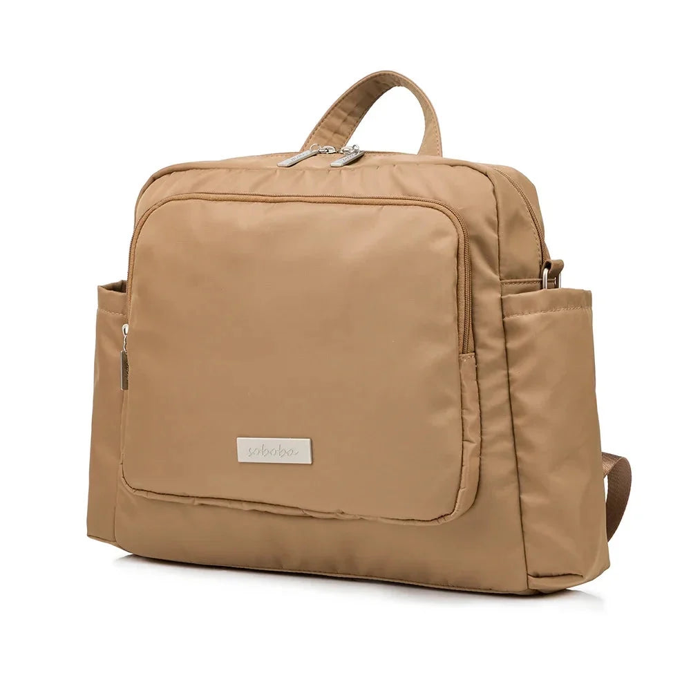 Waterproof tan diaper bag backpack with front zip pocket and top handle straps