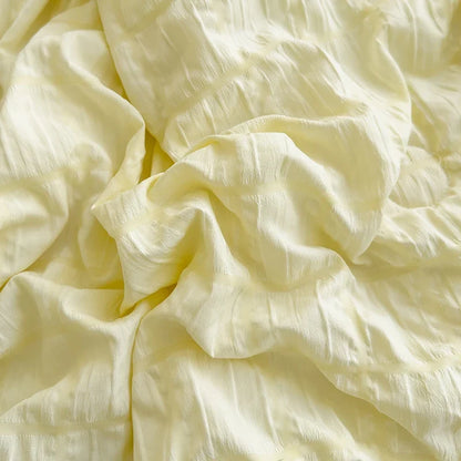 Yellow seersucker fabric detail with crinkle texture, folded for display