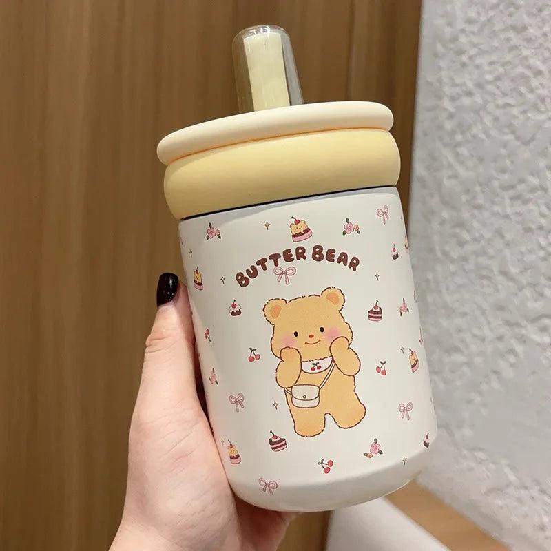 Butter Bear thermos cup with cream lid, clear straw, white body with standing bear graphic