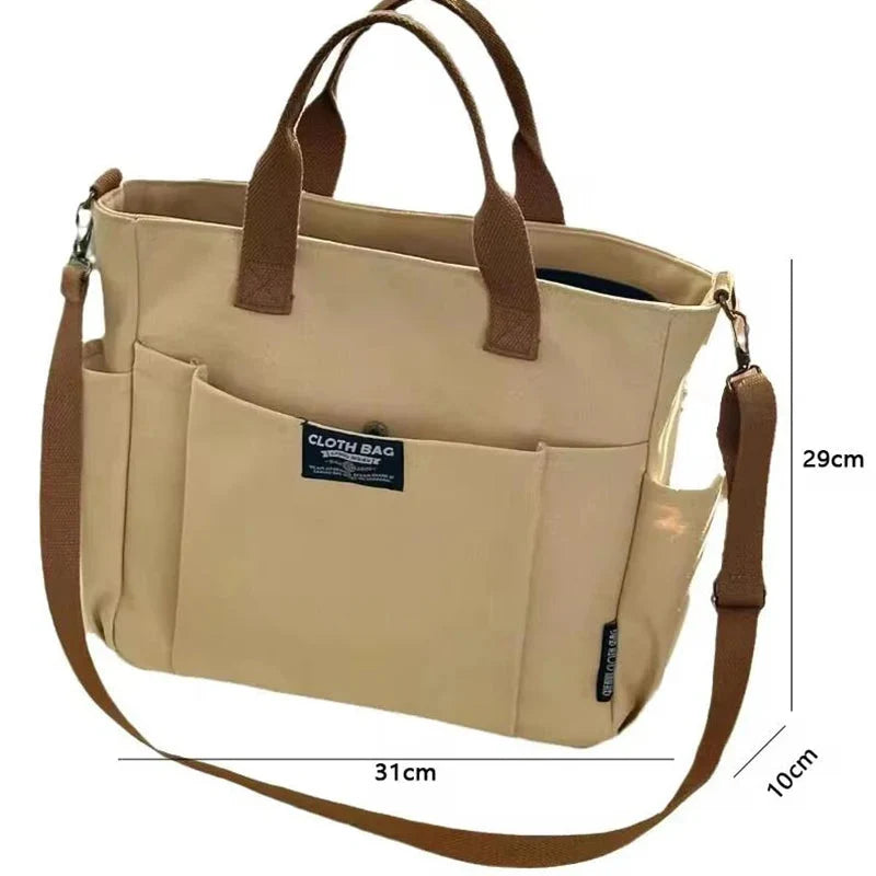 Khaki canvas single-shoulder tote bag, two top handles and long crossbody strap
