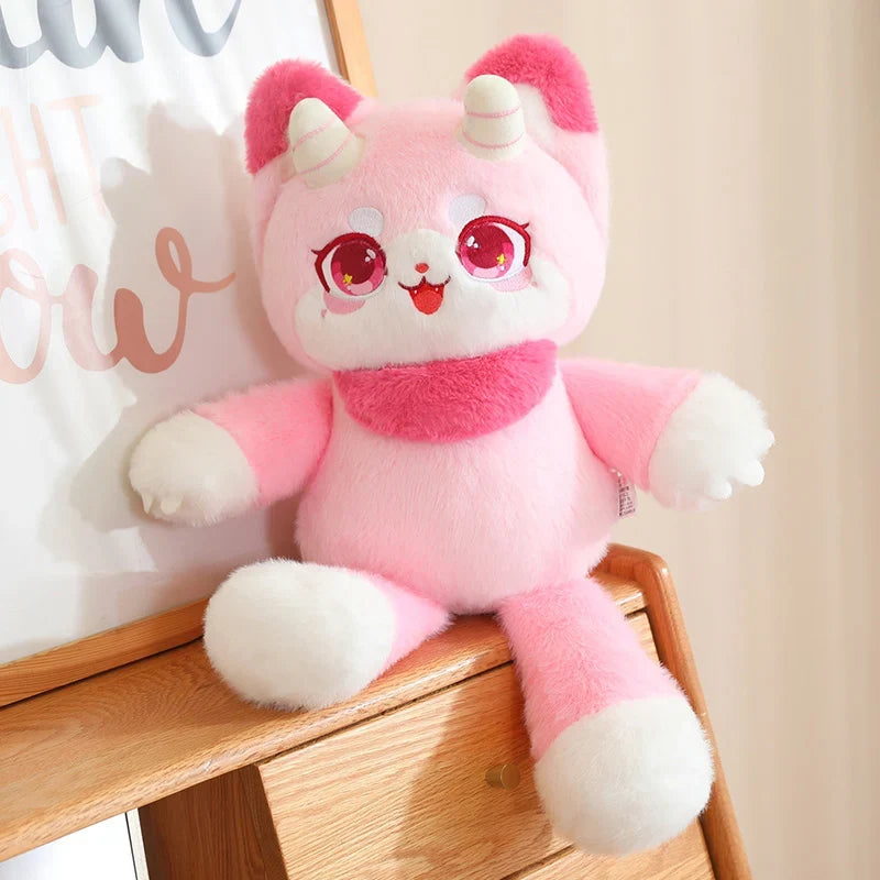 Dragon cat plushie in pink with white muzzle, red eyes, curled horn details