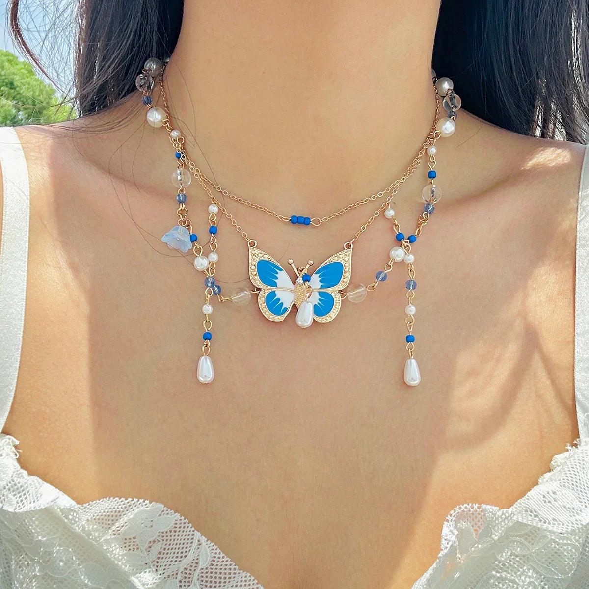 Butterfly imitation pearl multi-layer necklace with blue beads and white pearl teardrop drops