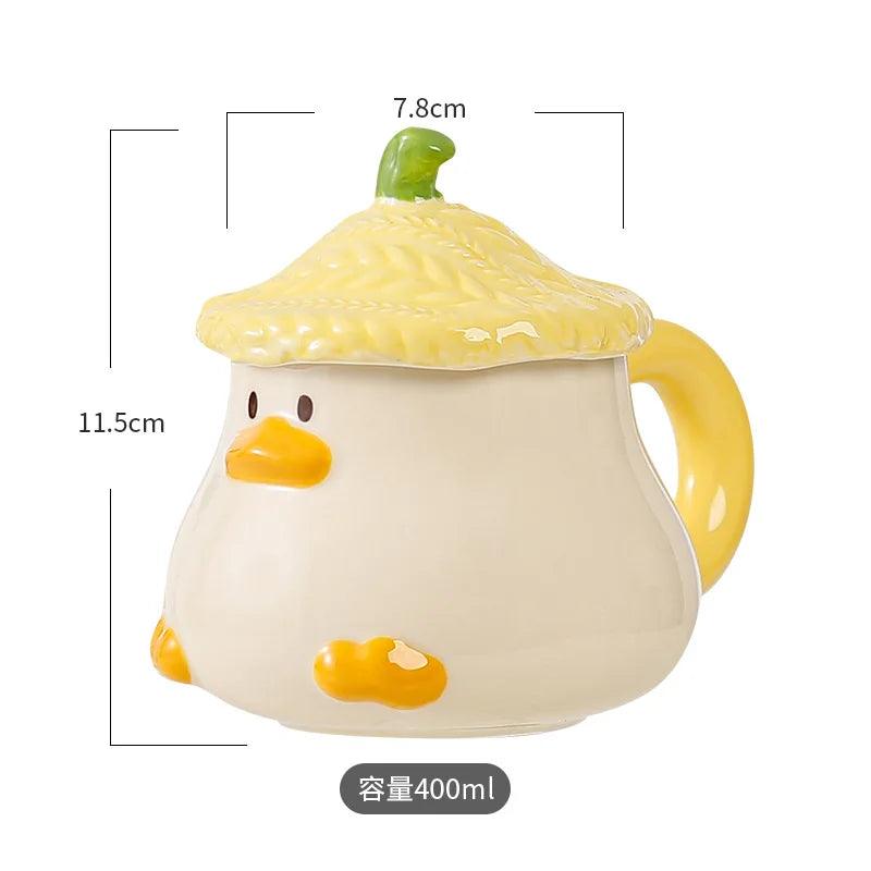 Duck-lid mug, cream cup with orange beak and foot accents, yellow side handle