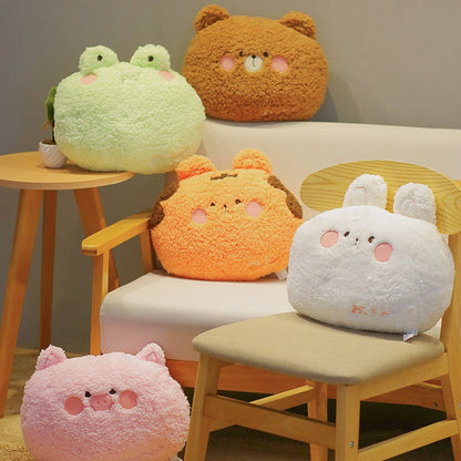Animal plush cushion pillows display: green frog, brown bear, orange tiger, white bunny