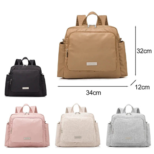 Brown diaper bag backpack with front zip pocket and side bottle compartments