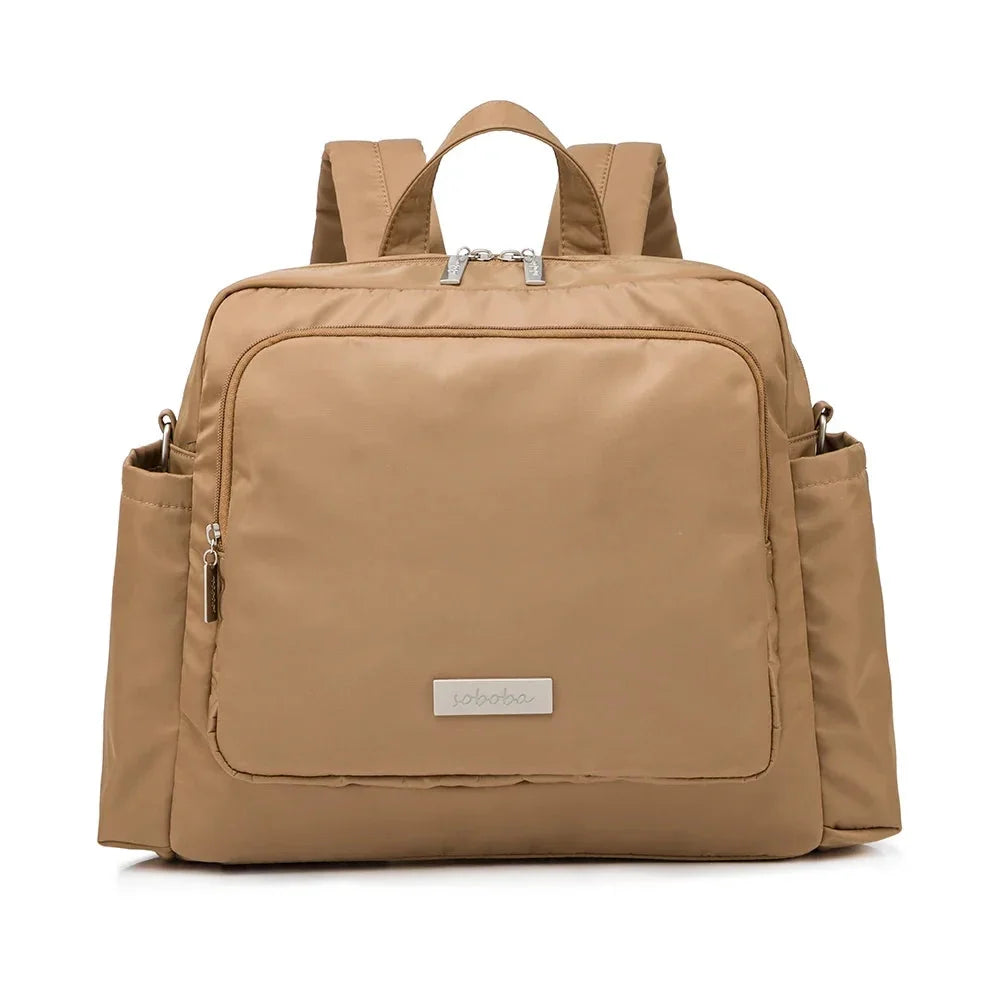 Tan diaper bag backpack with front zip pocket and side zip openings