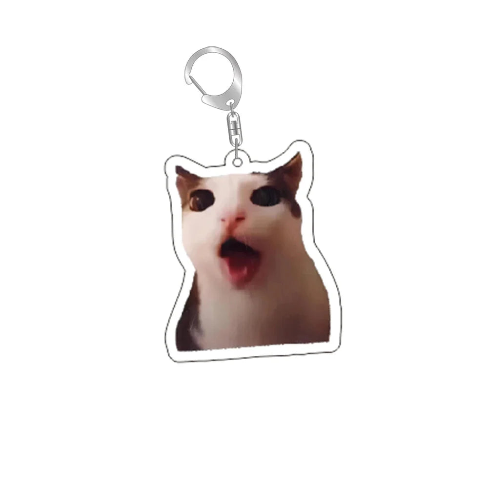 Funny cat face keychain with silver ring and clip; tan-and-brown cat shouting.