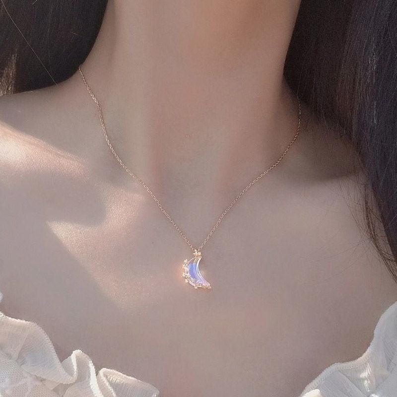 Moon pendant necklace with blue glazed crescent charm and small crystal star accents