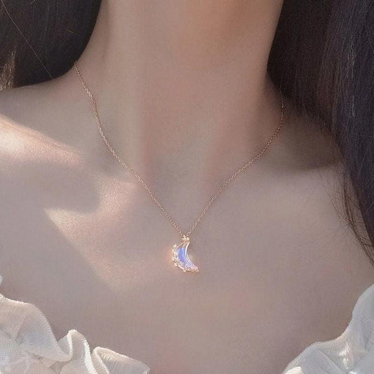 Moon pendant necklace with blue glazed crescent charm and small crystal star accents