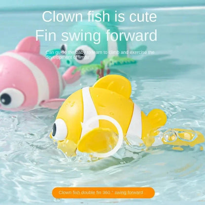 Yellow clown fish bath toy with white stripe and curved fins, floating in water.