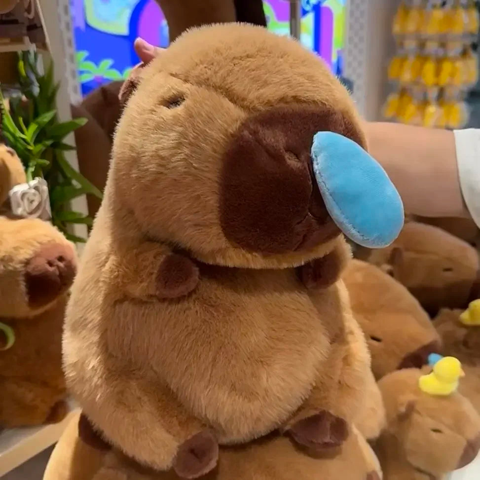 Sitting brown capybara plush with blue nose and stitched eyes