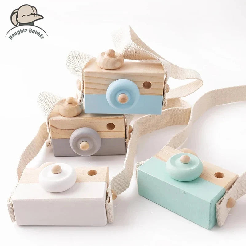 Wooden camera pendant toy set with beige straps, showing light blue, white, and mint bodies