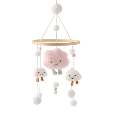 Wooden baby crib mobile with pink bear plush, white cloud characters, and hanging beads