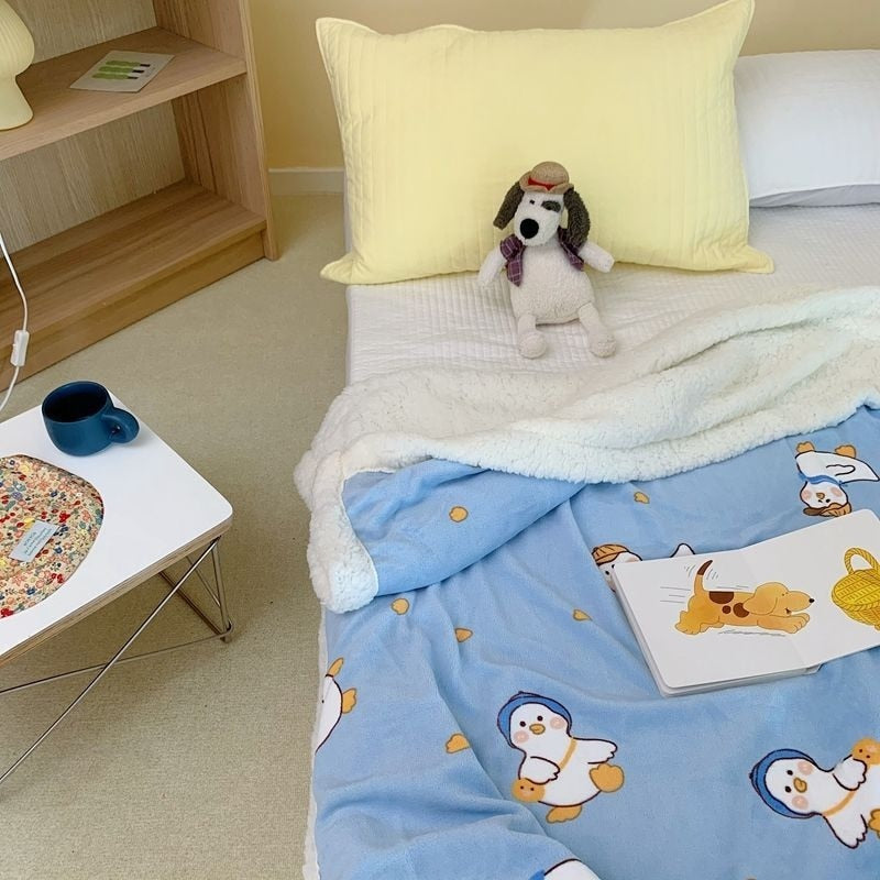Lamb fleece blanket in light blue with cartoon animals print and white sherpa trim