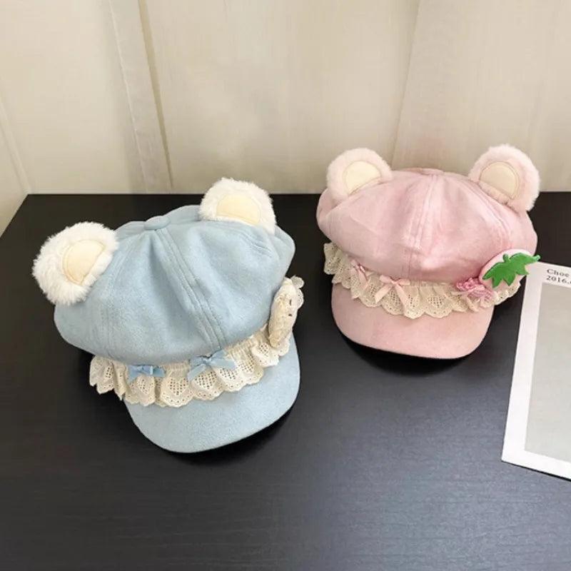 Blue and pink bear hats with lace trim and ear plush details