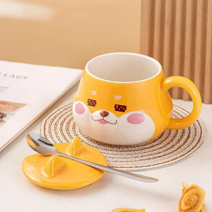 Yellow dog-face mug with handle, stainless spoon and lid resting on a coaster