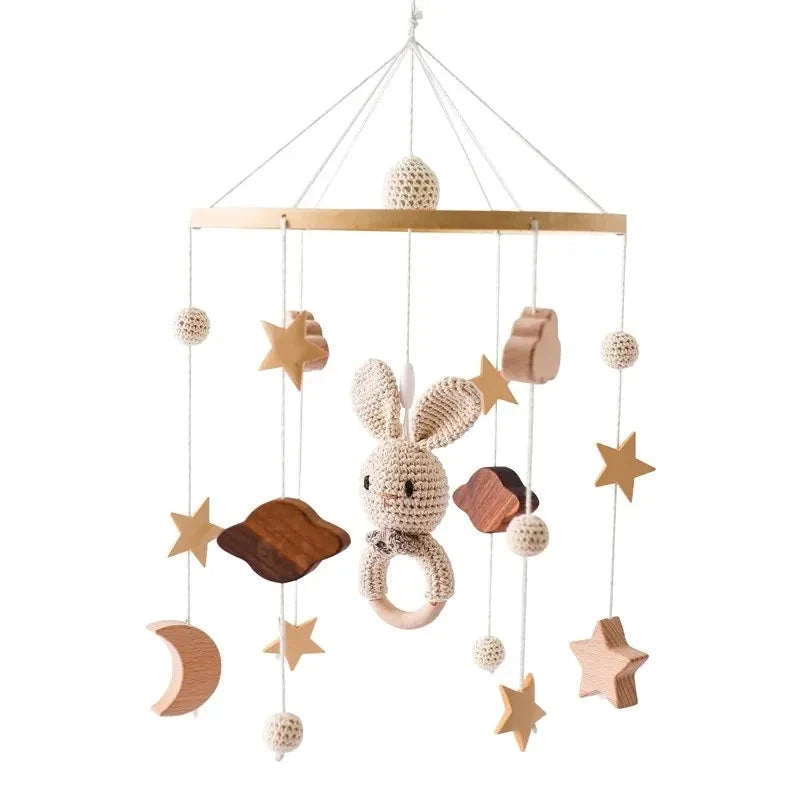 Baby crib mobile with hanging bunny, stars, moon, and cloud ornaments
