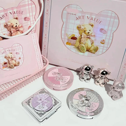 Bear-themed makeup compacts and eyeshadow palette arranged in gift packaging