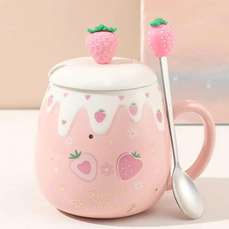 Pink ceramic mug with white lid, strawberry topper, and spoon; strawberry heart print