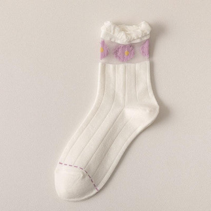 White ribbed socks with small purple, yellow, and pink flower accents