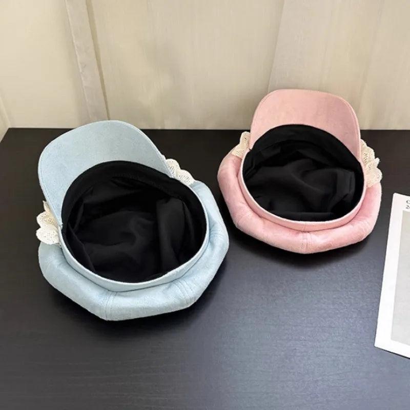 Bear hats in blue and pink, showing inner black lining and lace edge