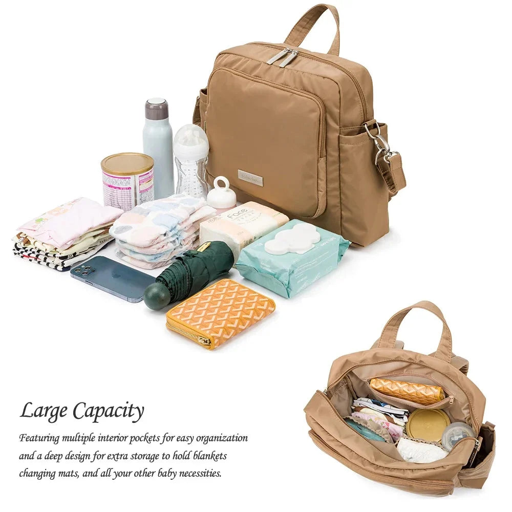 Tan waterproof diaper bag backpack with open top and organized interior compartments