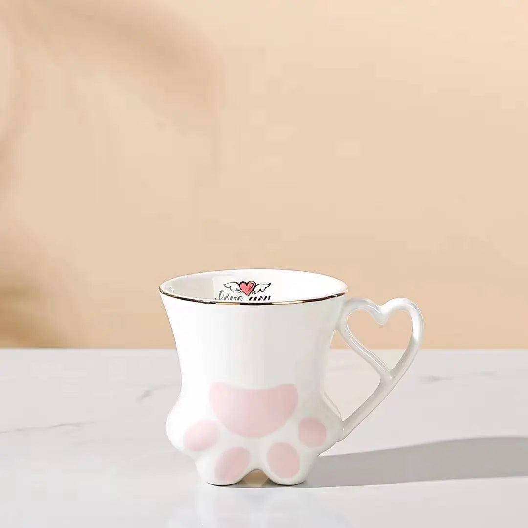 White cat paw mug with heart-shaped handle and pink paw pad accents